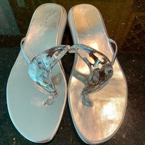 Tory Burch brand new. Silver leather thong sandal with lucite enclosed wavy logo